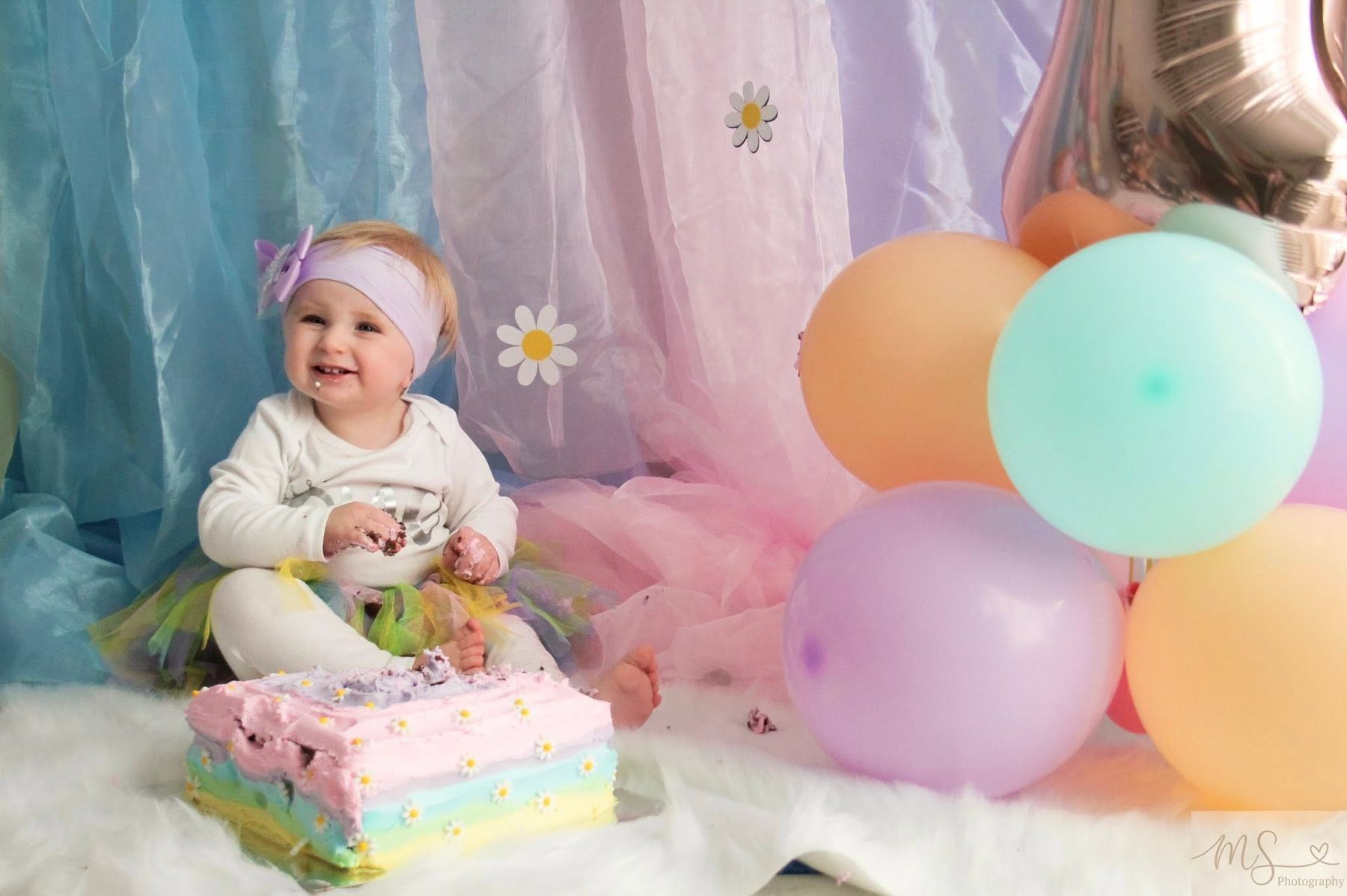 First birthday cake smash set-up with pastel balloons